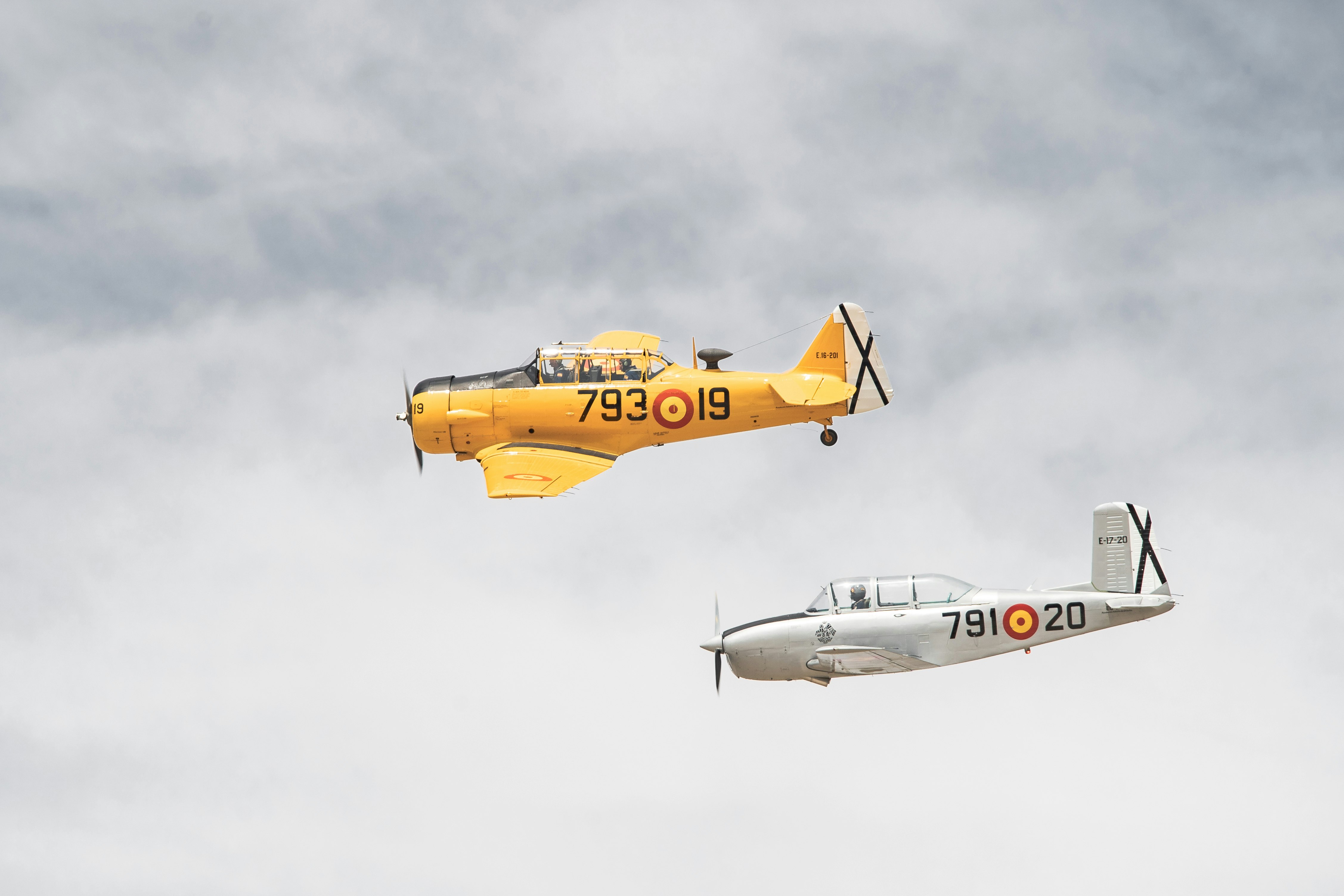 white and yellow jet plane in mid air